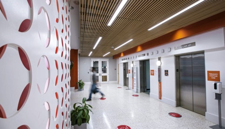 Interior shot of office building with person walking