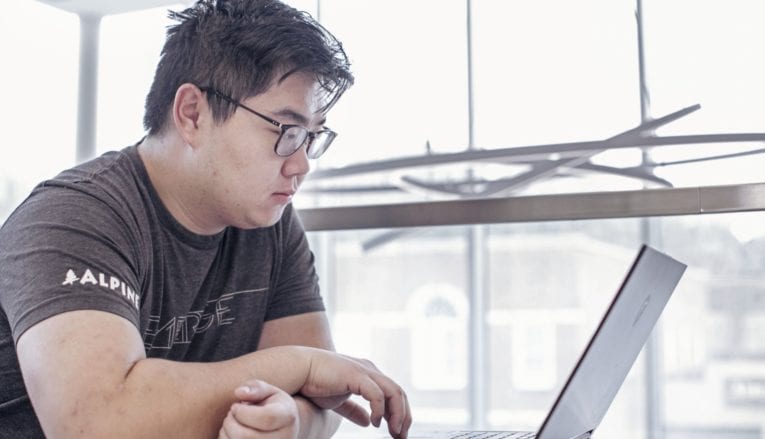 male student using computer