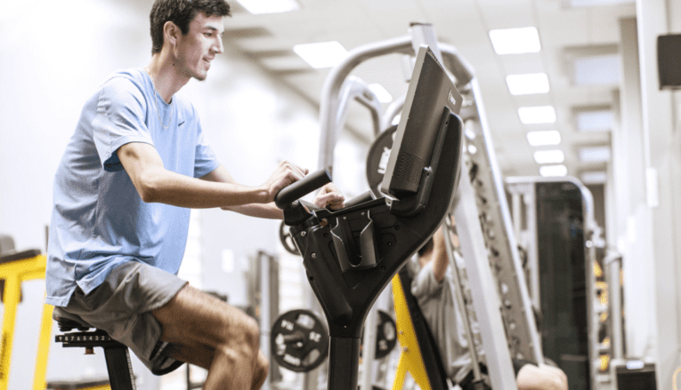man using an exercise machine in the gym