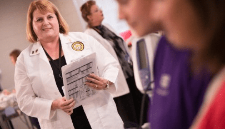 Nursing professor smiling at students