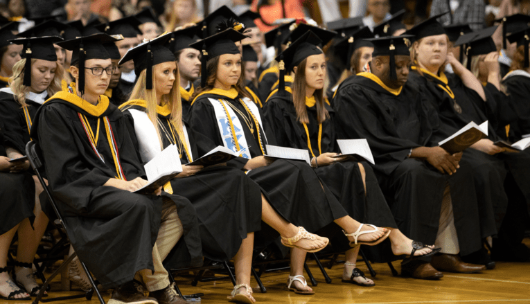 pfeiffer graduates sitting in graduation robes