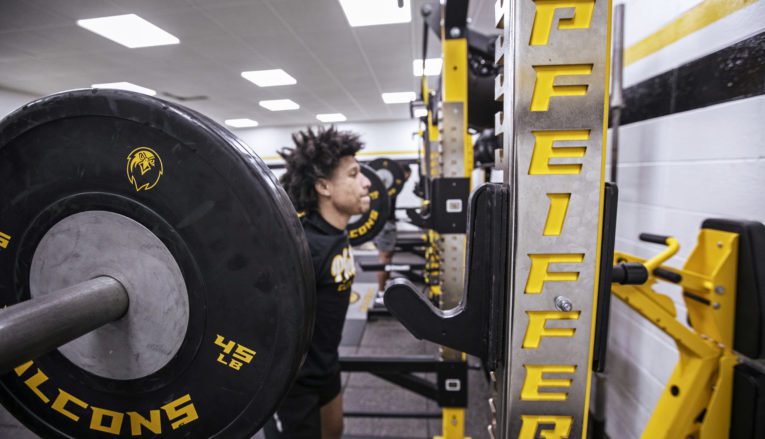 student lifting weights