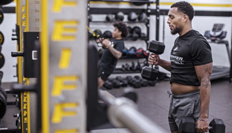 student lifting weights