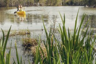 Two students kayaking on a lake
