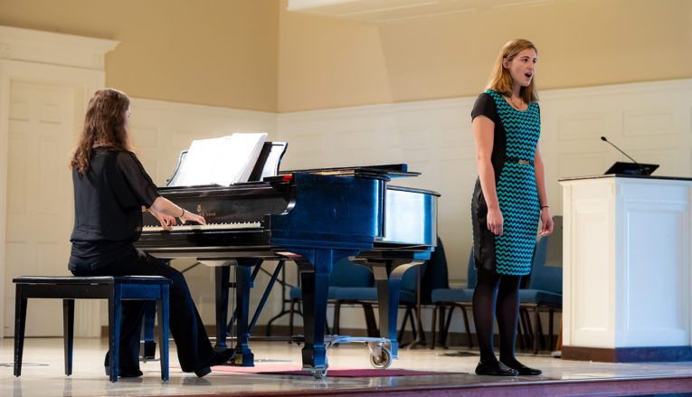 Students singing and playing piano