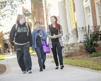 Three students walking outside
