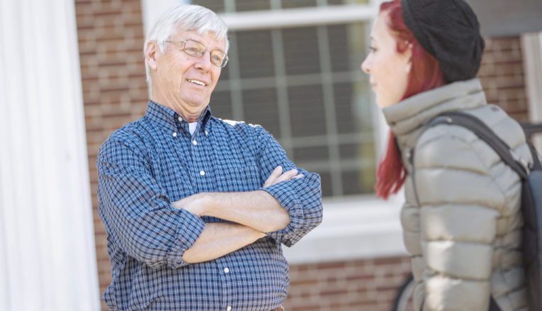 Pfeiffer student talking to professor outside