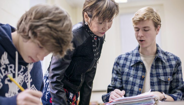 Professor helping student in class