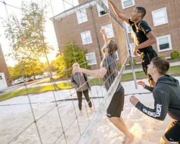 Students playing volleyball outside
