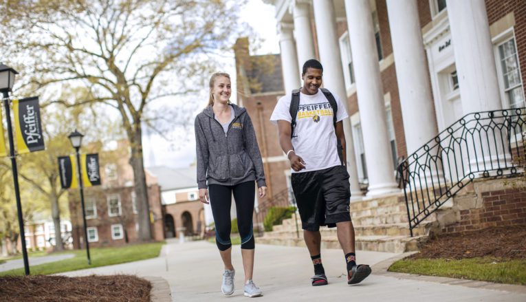 Two students walking outside on Pfeiffer campus