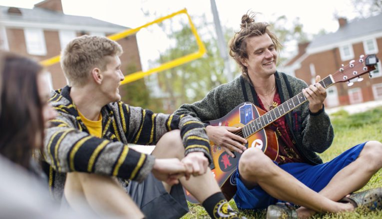 Group of students sitting on grass