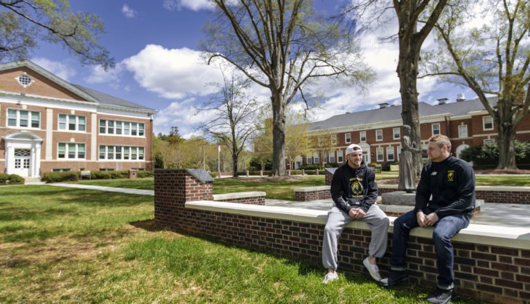 Students sitting outside on campus