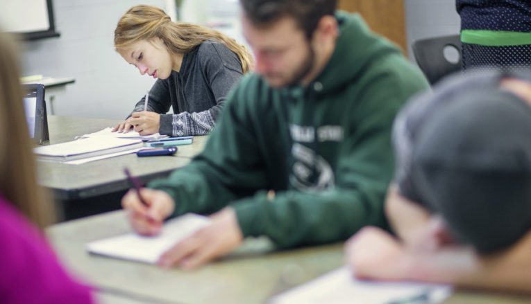 students writing in class