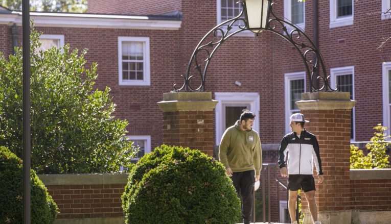 Two young men walking on campus